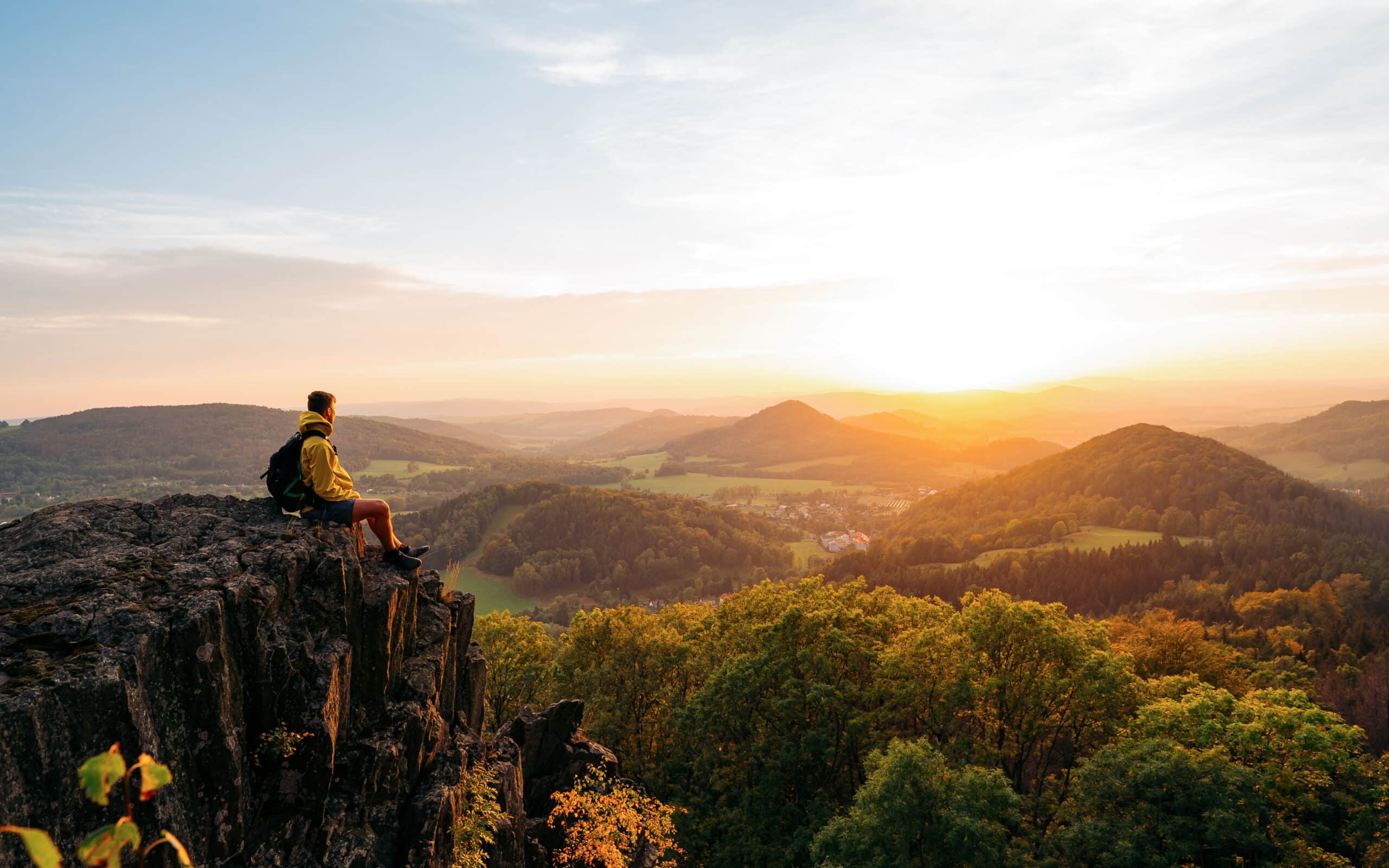 Confident,man,sitting,on,the,edge.,amazing,view,in,hilly