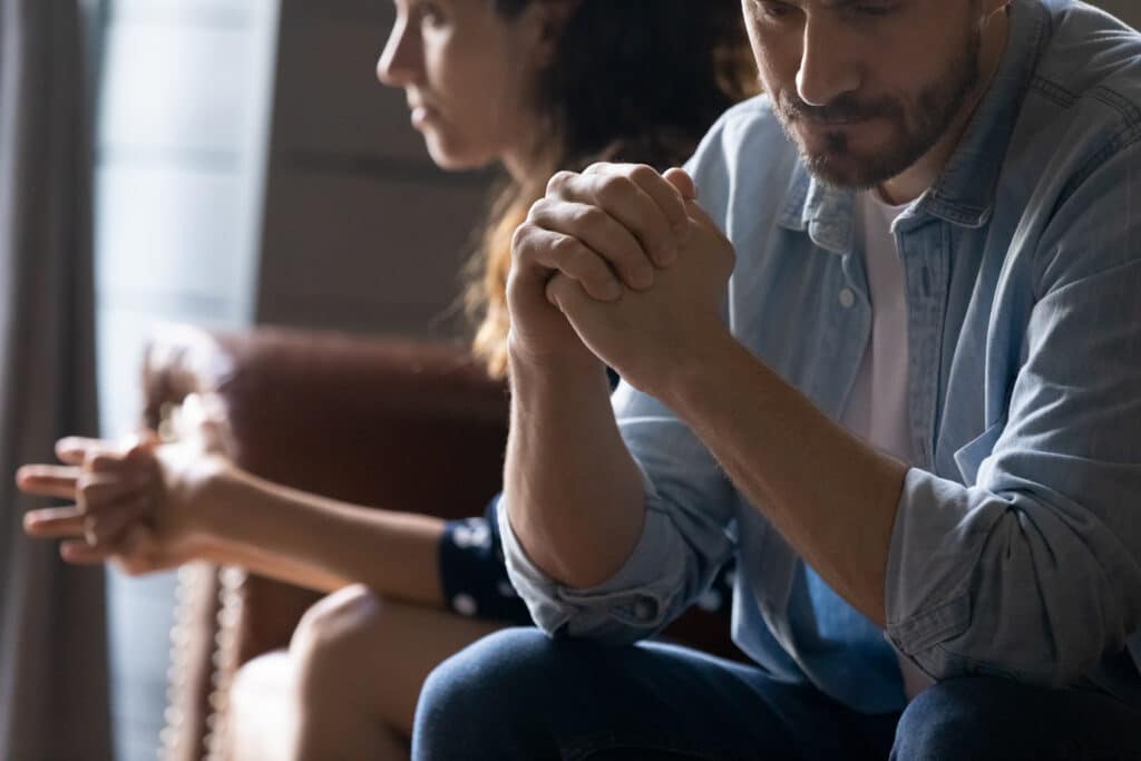 Crop,close,up,of,unhappy,young,couple,sit,separate,have - Jonathan Olvera Counseling Couple sitting together in a Dallas therapy office during a faith-based counseling session